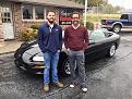 (L) Salesman Cody and (R) co-pilot Bret stand with the car after the paperwork was completed